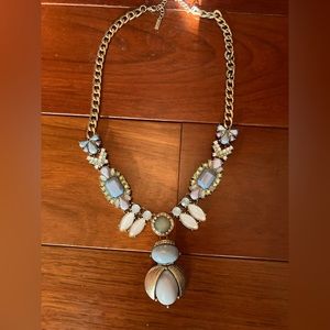 Jewelmint chunky gold necklace with blue, green, and white stones.